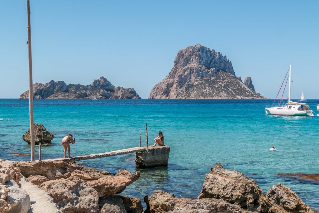 Cala d'Hort beach with Es Vedrà rising from the sea